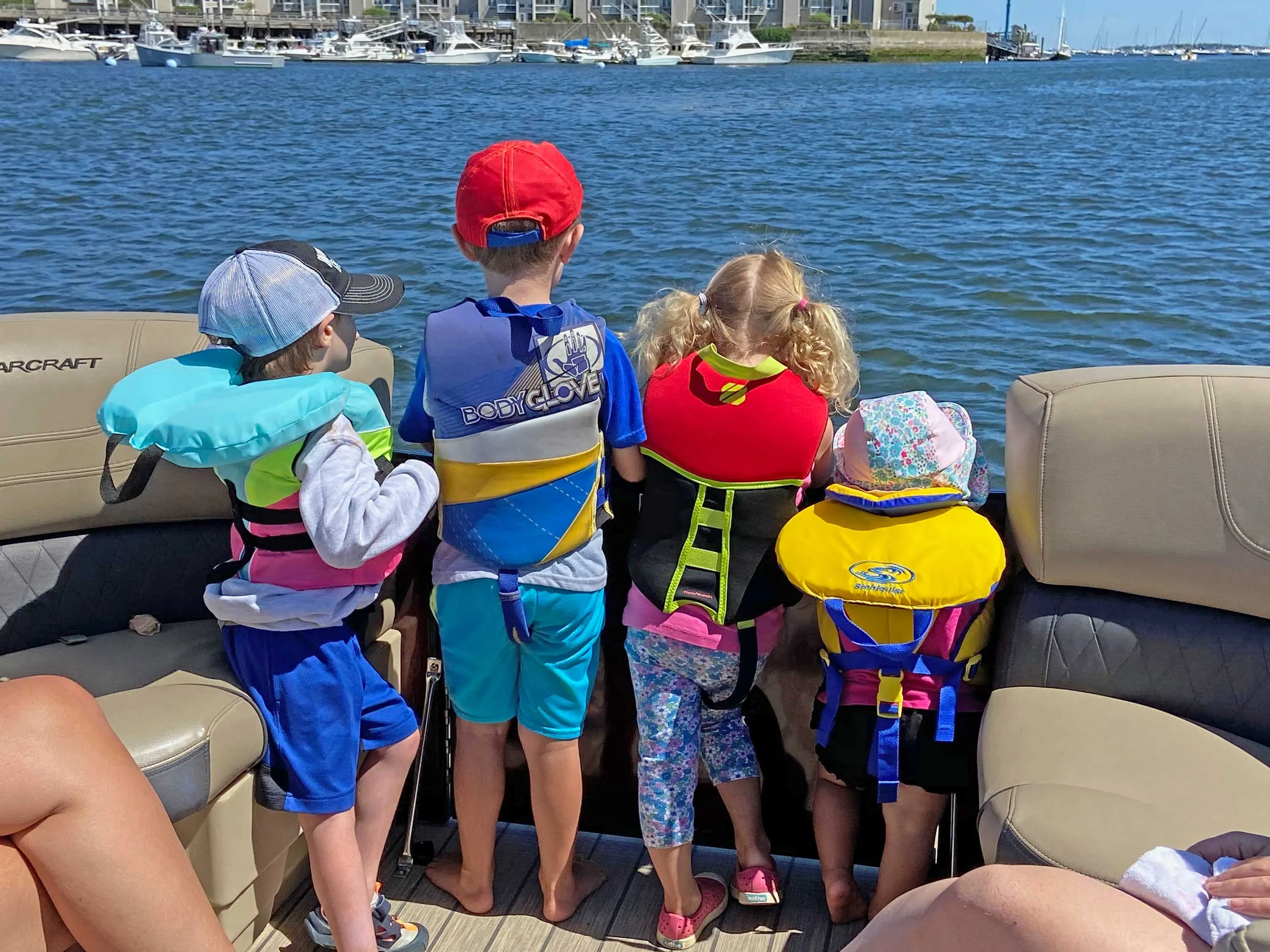 Kids on bow of boat.
