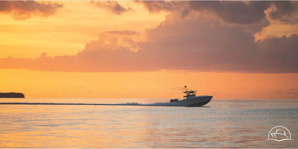 A Carefree Boat Club member cruising the Navesink River in Red Bank, New Jersey on a crisp fall day, with colorful autumn leaves reflecting on the water